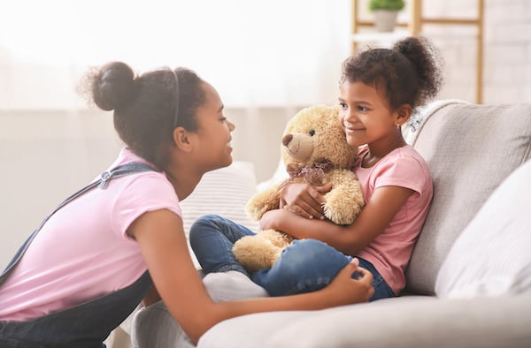 black-teen-girl-playing-with-her-little-sister-at--9E3F7AV black-teen-girl-playing-with-her-little-sister-at--9E3F7AV